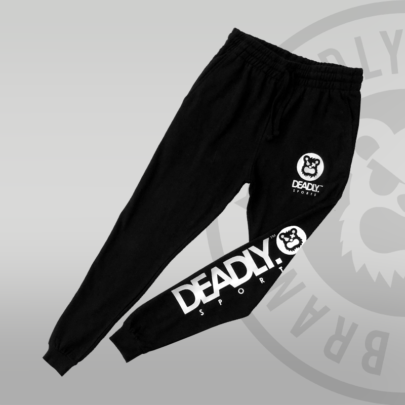 DEADLY. SPORTS Logo in white on the front and back leg of a pair of jog bottoms.